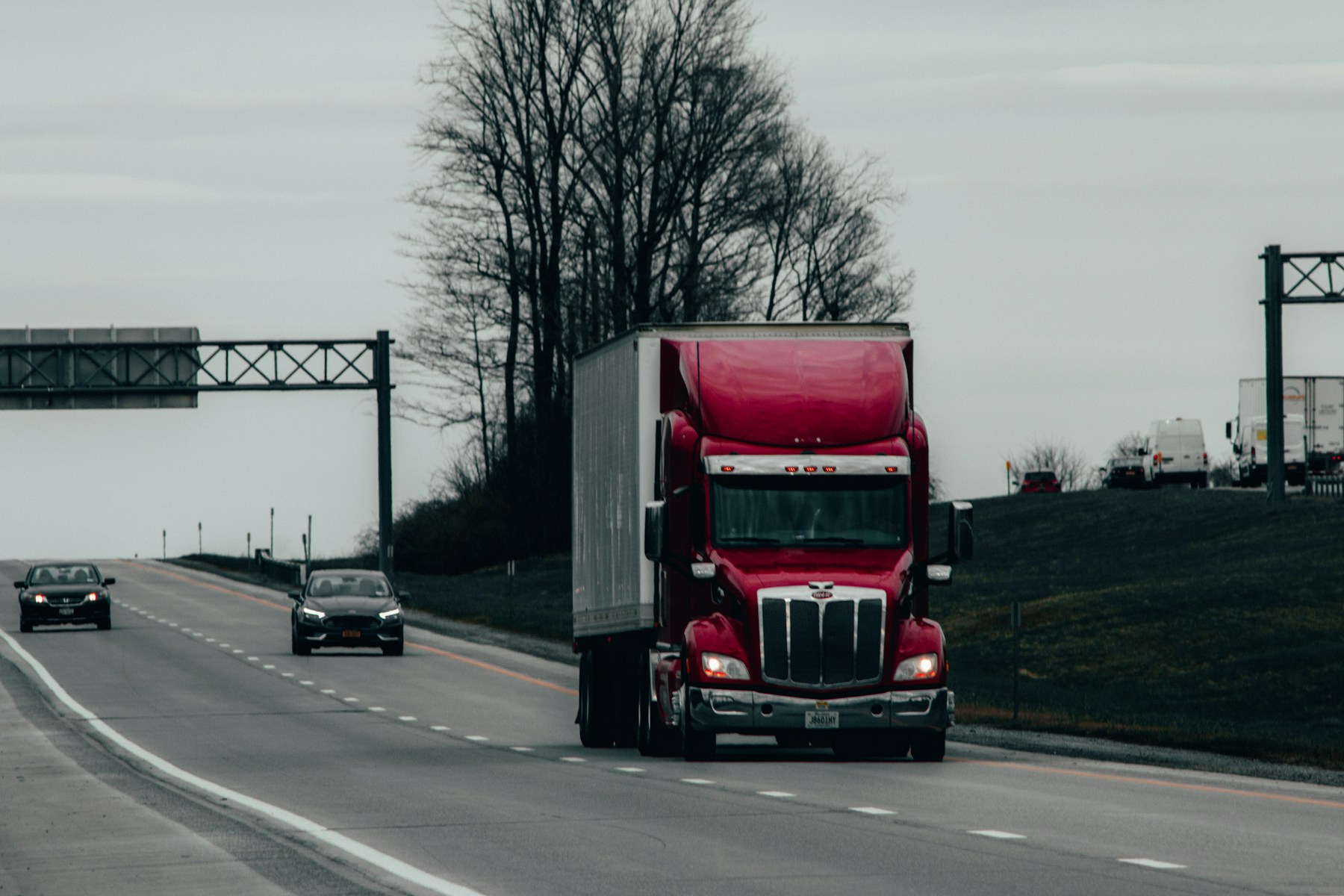 Red semi truck transporting freight on a highway
